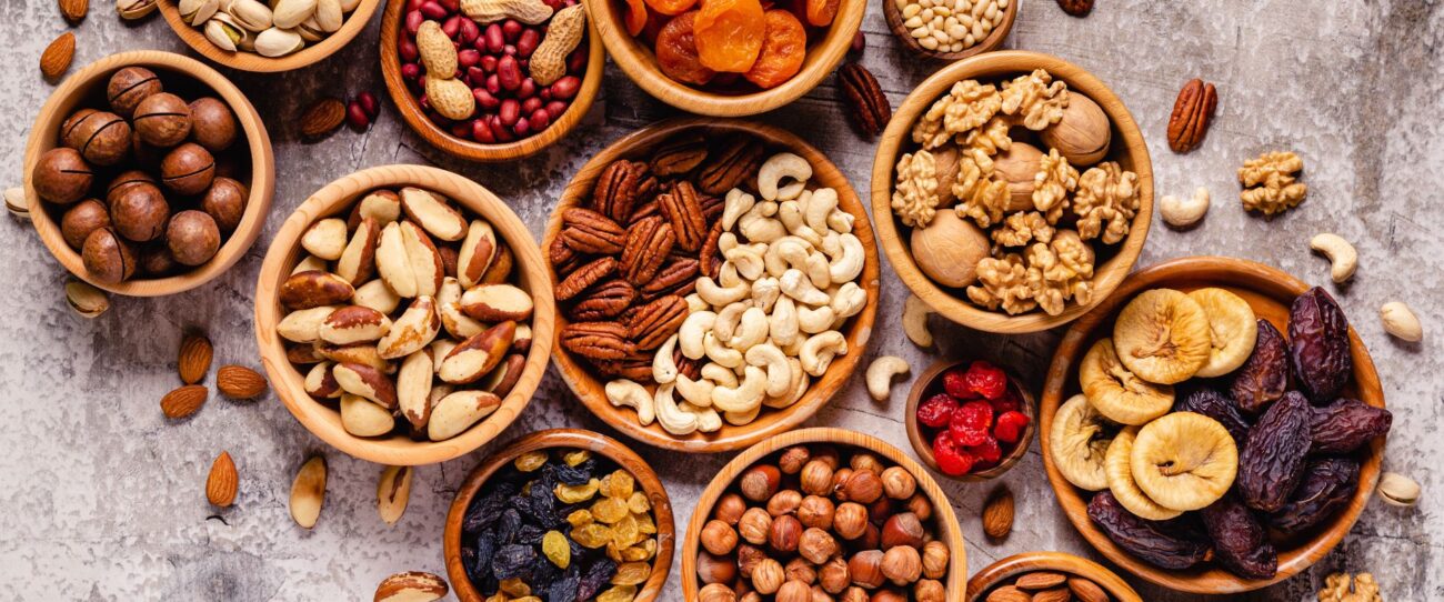An assortment of bowls containing Dry fruits and nuts
